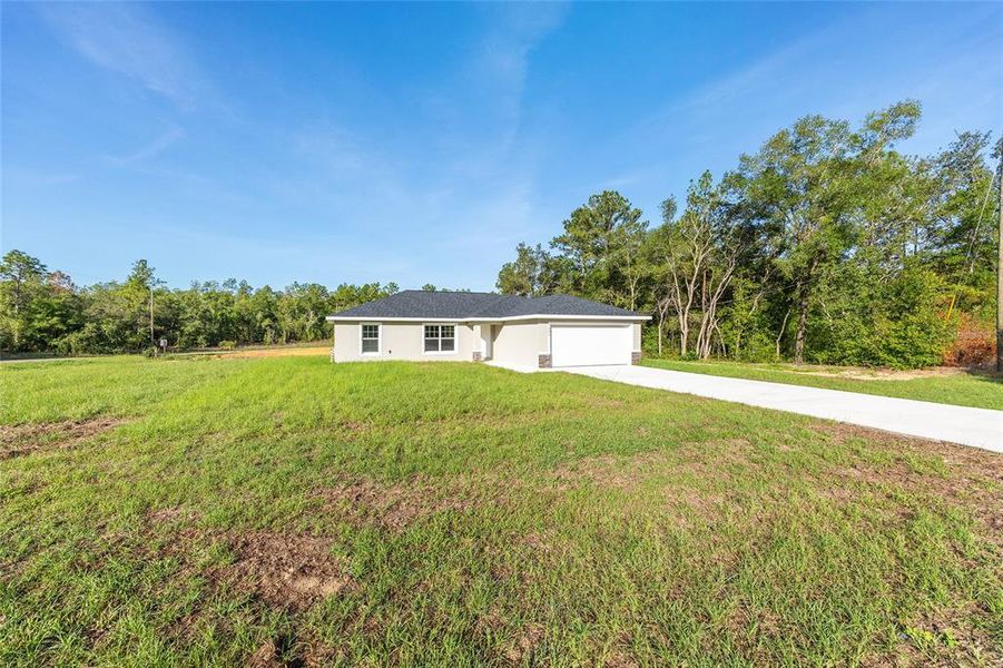 Front exterior of a new home in , Citrus Springs, FL, highlighting curb appeal (Image 14).