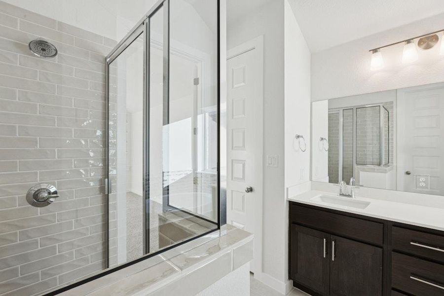 Bathroom featuring vanity and a stall shower Bathroom featuring vanity and a stall shower
