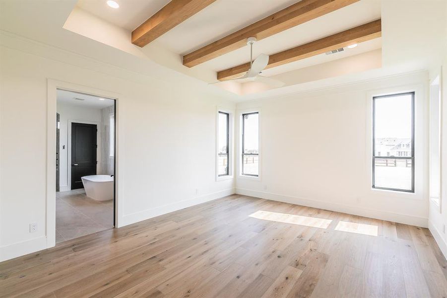 Spare room featuring light wood-style flooring, beamed ceiling, a ceiling fan, and recessed lighting