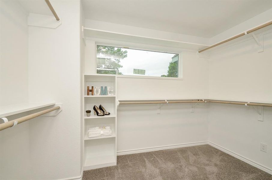 Primary closet:Photo is not of the actual home, but is an inspirational photo of the the builder's model and may depict options, furnishings, and/or decor features that are not included.Photos of home will be uploaded shortly.