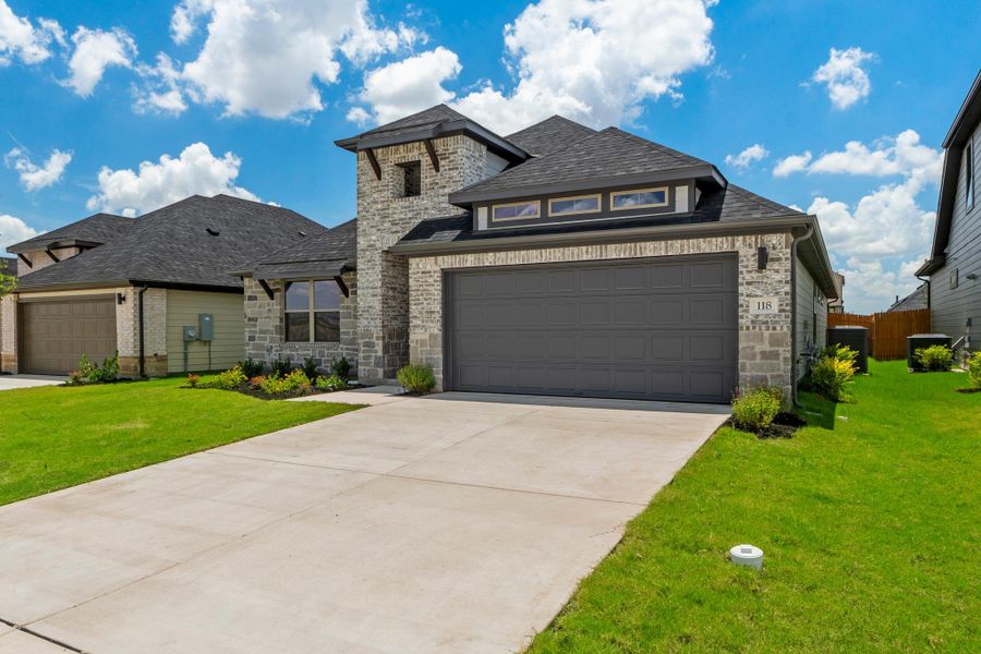 Front exterior of a new home in Prairie Winds, Hutto, TX, highlighting curb appeal (Image 22).