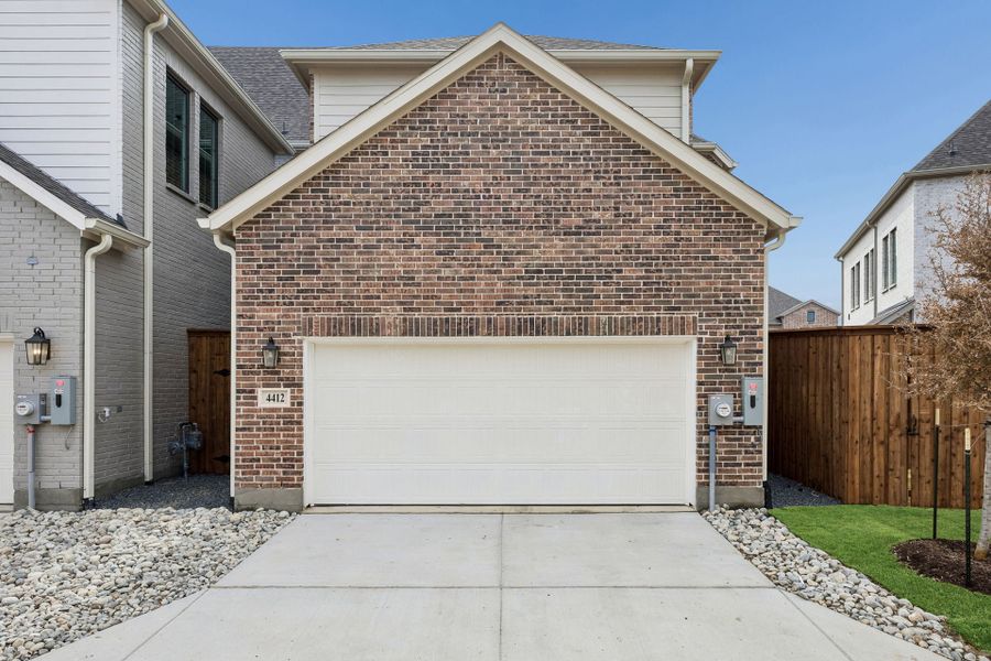 Front exterior of a new home in Newman Village Townhomes, Frisco, TX, highlighting curb appeal (Image 25).