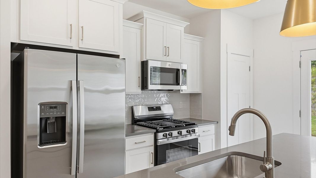 Contemporary kitchen featuring premium countertops and streamlined cabinetry at Marion Square Contemporary kitchen featuring premium countertops and streamlined cabinetry at Marion Square