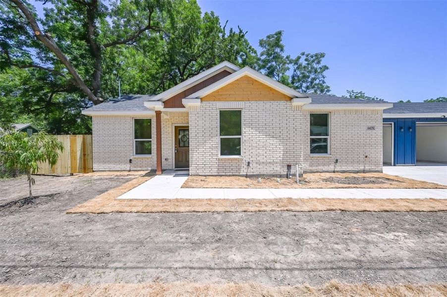 Light brick exterior with contrasting wood-look gables and columns Light brick exterior with contrasting wood-look gables and columns