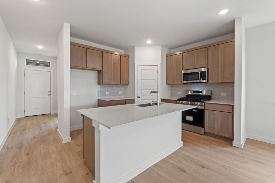 Kitchen in the Pearl home plan by Trophy Signature Homes – REPRESENTATIVE PHOTO