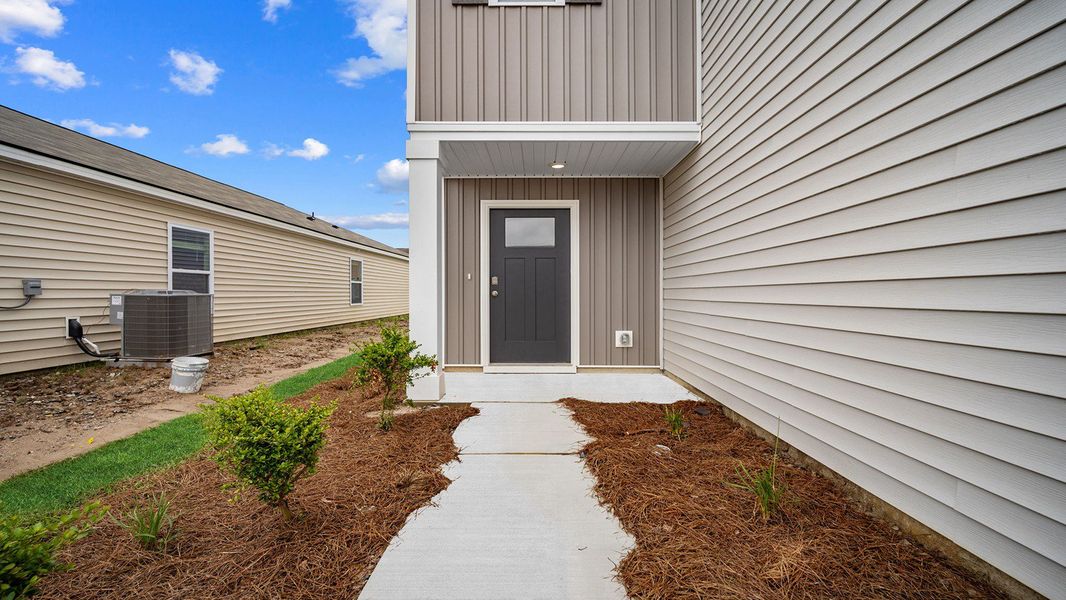 Front exterior of a new home in Rice Hope, Port Wentworth, GA, highlighting curb appeal (Image 2). Front exterior of a new home in Rice Hope, Port Wentworth, GA, highlighting curb appeal (Image 2).