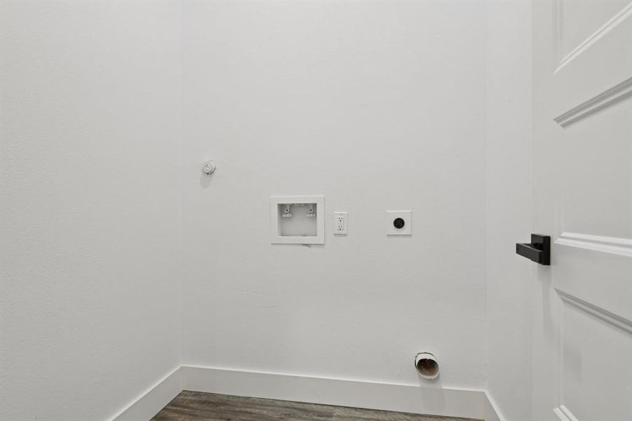 Laundry area featuring washer hookup, electric dryer hookup, gas dryer hookup, and dark wood-style floors Laundry area featuring washer hookup, electric dryer hookup, gas dryer hookup, and dark wood-style floors