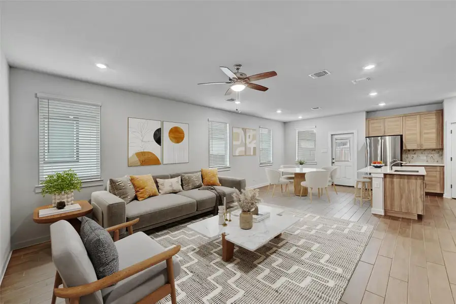Living area featuring light wood-style flooring, recessed lighting, and a ceiling fan Living area featuring light wood-style flooring, recessed lighting, and a ceiling fan