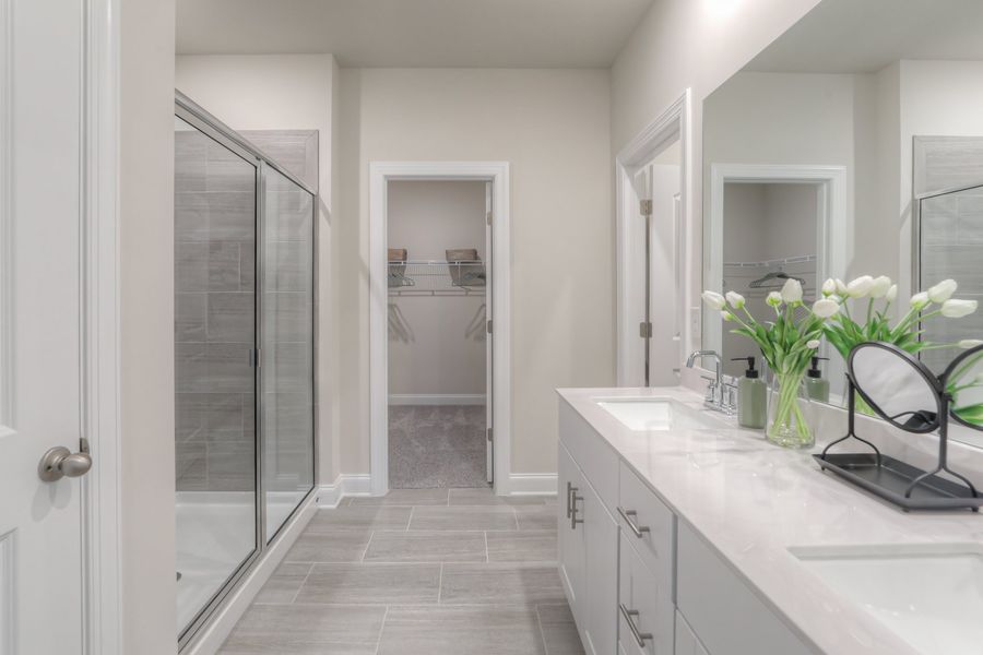 The primary bathroom offers dual-vanity sink and a walk-in closet.