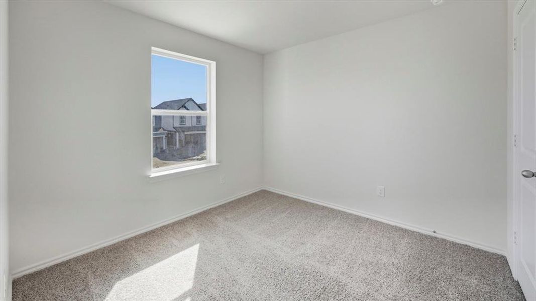 Carpeted spare room with baseboards