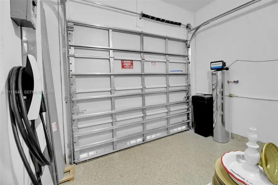 Attached electric vehicle charging station, overhead metal garage door, epoxy-coated flooring, and installed water filtration system Attached electric vehicle charging station, overhead metal garage door, epoxy-coated flooring, and installed water filtration system