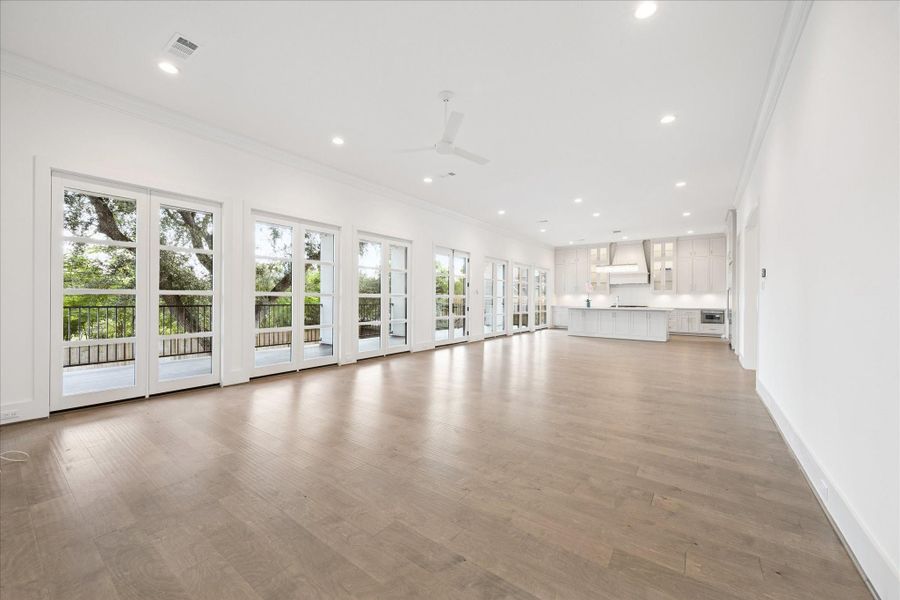 A wall of fixed doors with one set of French doors provide gorgeous views to the trees and greenery in the back yard. Opportunities to have two living spaces or a breakfast area and family room. A wall of fixed doors with one set of French doors provide gorgeous views to the trees and greenery in the back yard. Opportunities to have two living spaces or a breakfast area and family room.