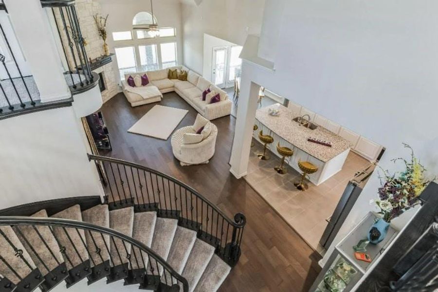 Stairway with a towering ceiling and hardwood / wood-style flooring