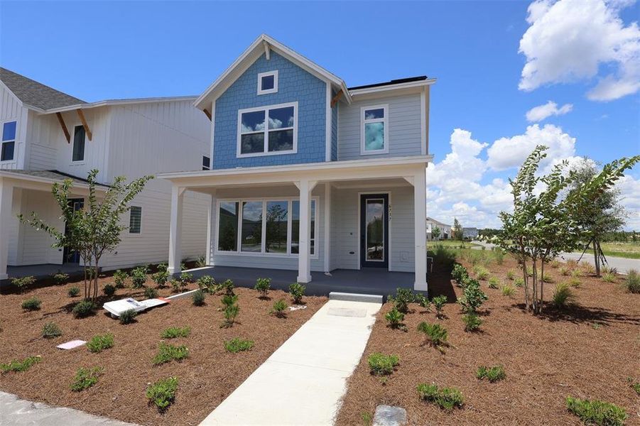 Front exterior of a new home in Weslyn Park in Sunbridge 34', St. Cloud, FL, highlighting curb appeal (Image 9).