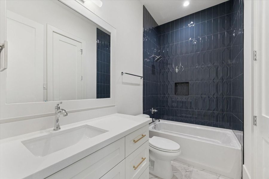 Secondary Bathroom — Full bath with a sleek tub/shower combo and contemporary tilework.