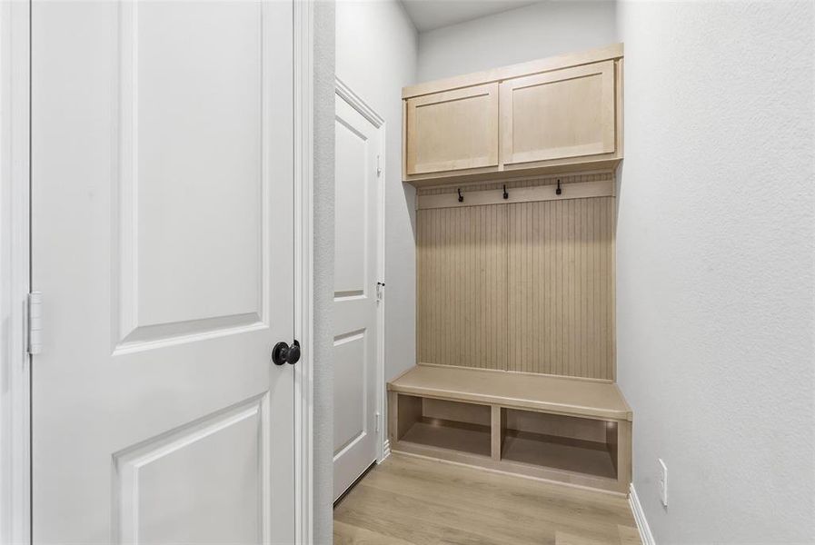 Mudroom featuring light wood-style floors and baseboards Mudroom featuring light wood-style floors and baseboards