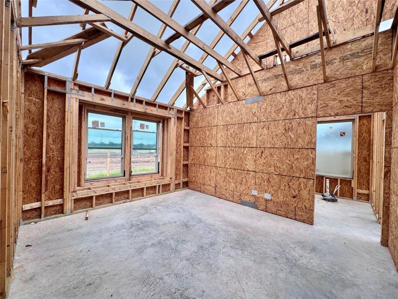 Even taller ceilings in the primary bedroom with over 13' vaulted ceilings and a build in bench for all that laundry we'll eventually fold.