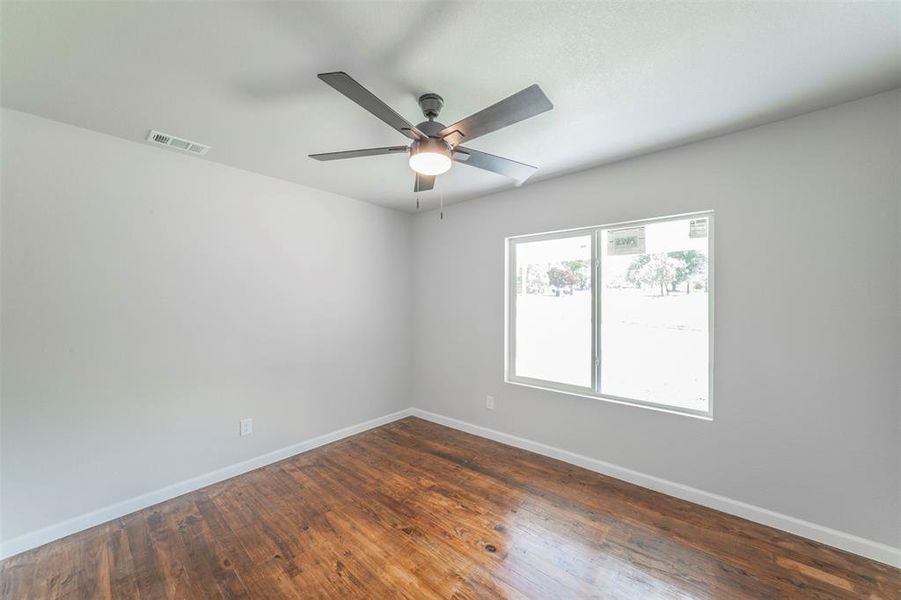 Bedroom featuring wood-type flooring, plenty of natural light, and ceiling fan