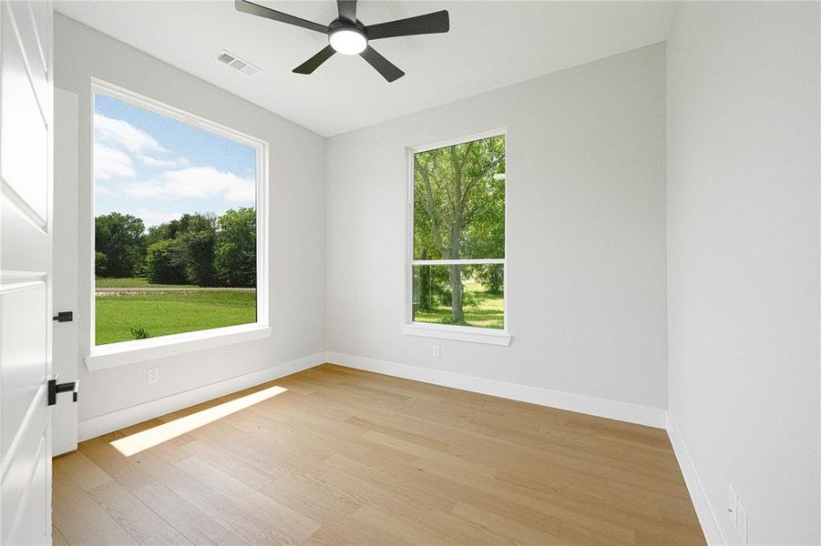 Unfurnished room with light wood-style flooring, ceiling fan, and baseboards Unfurnished room with light wood-style flooring, ceiling fan, and baseboards