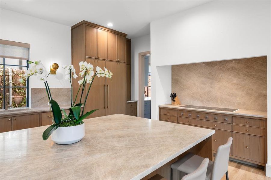 Kitchen featuring large quartzite island and breakfast bar