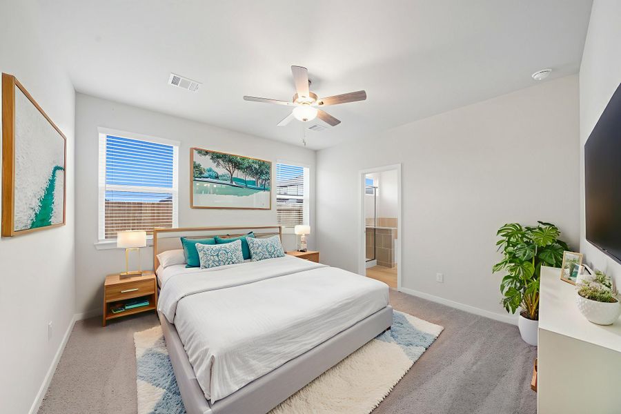 A bedroom with a bed and a fan.