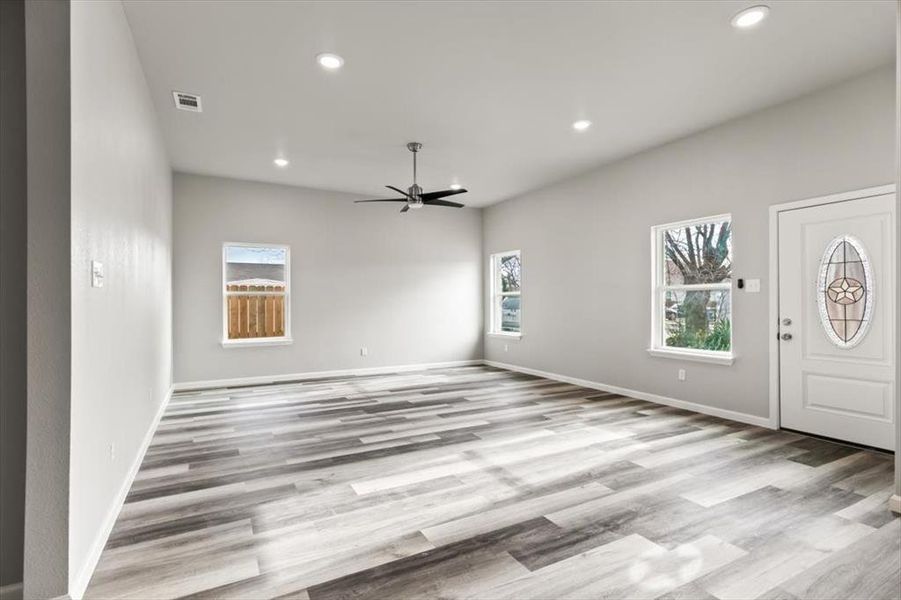 Foyer with ceiling fan and light wood-type flooring