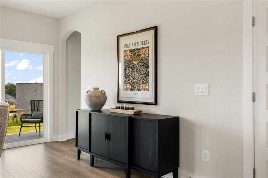 Hardwood flooring extends throughout this well-lit Hardwood flooring extends throughout this well-lit