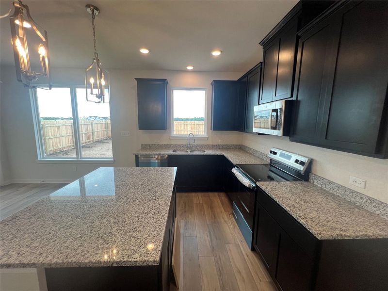 A well-appointed kitchen offers ample counter space, an island, and modern appliances.