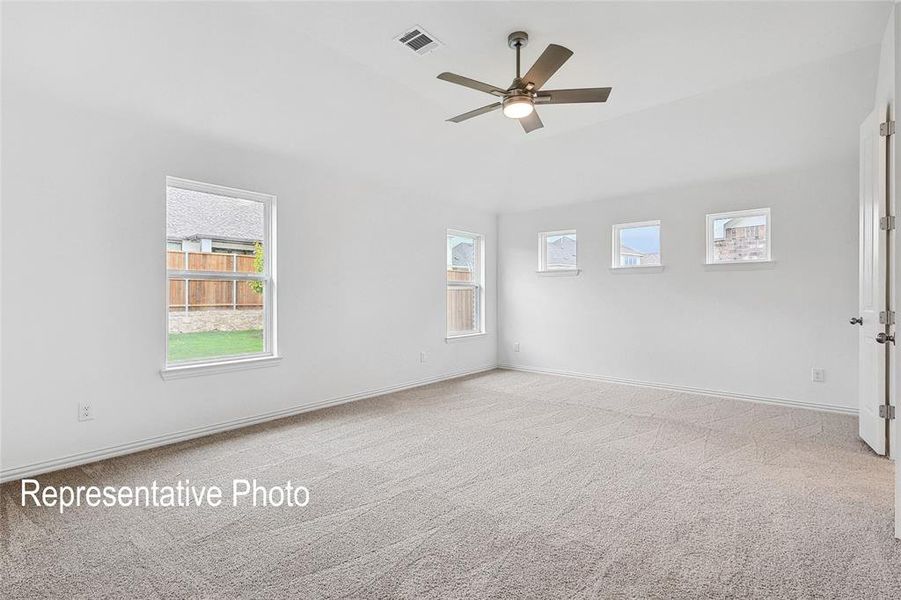 Spacious room featuring neutral carpeting and white painted walls