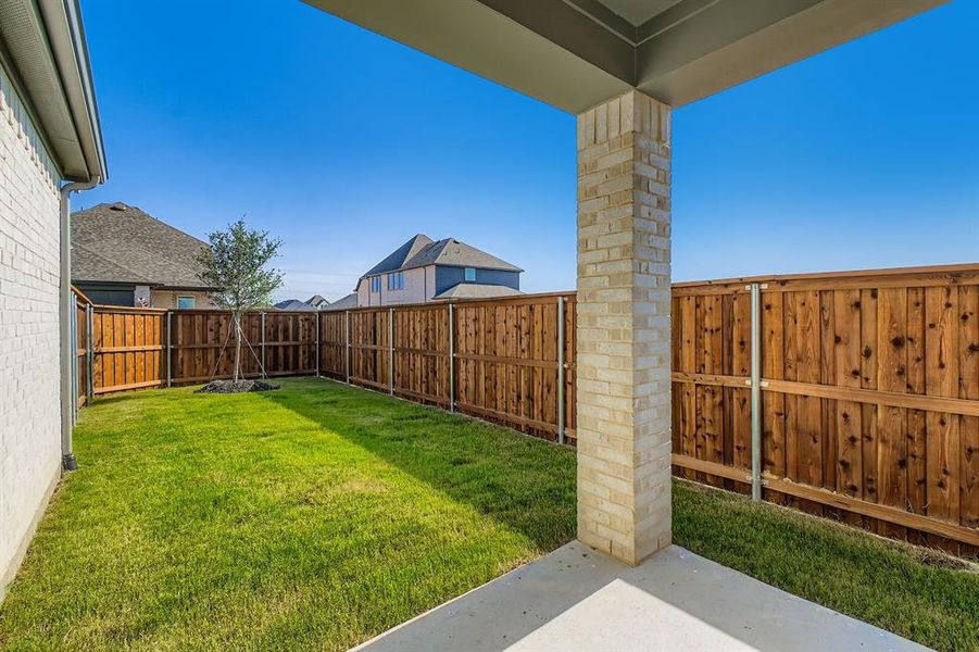 Fenced backyard featuring a patio area
