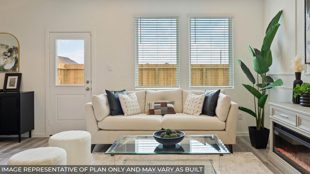 Living area featuring wood-finish flooring, white walls, and a glass-paned exterior door