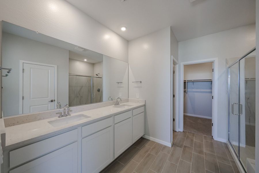 A bathroom with a large mirror.