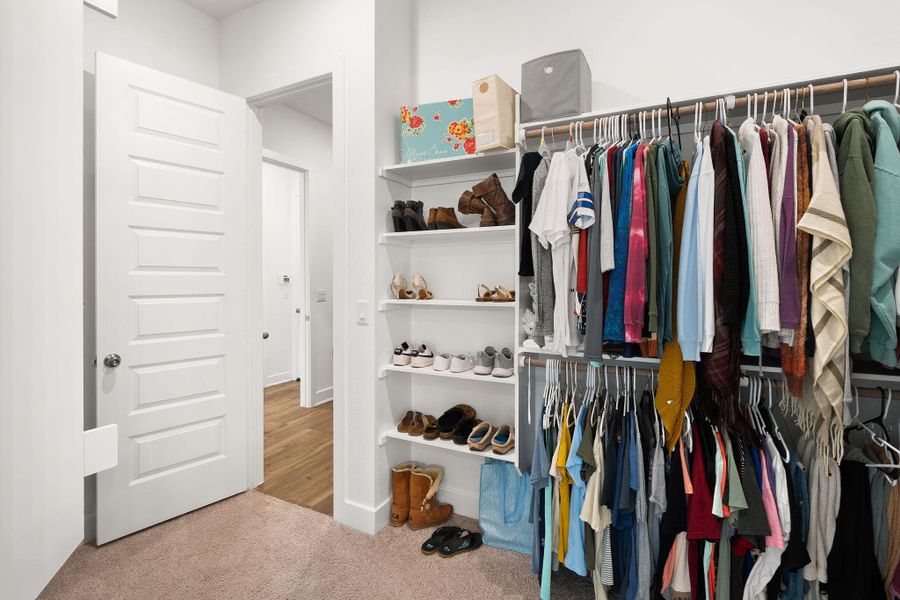 Streamlined closet system offers extensive hanging space and convenient shelving for shoes and accessories.