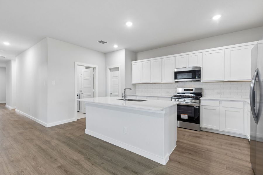 Kitchen in the Oscar home plan by Trophy Signature Homes – REPRESENTATIVE PHOTO