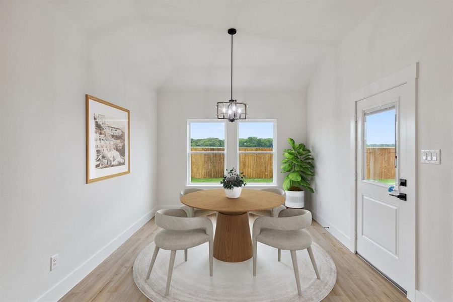 Dining space featuring a wealth of natural light, a chandelier, and light wood finished floors