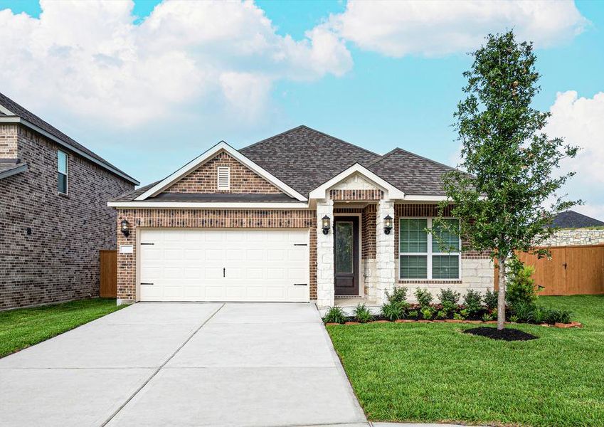 Brick and stone exterior with front yard landscaping