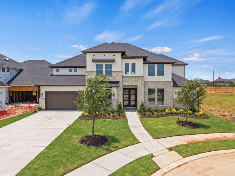 Front exterior of a new home in Harvest Green, Richmond, TX, highlighting curb appeal (Image 18). Front exterior of a new home in Harvest Green, Richmond, TX, highlighting curb appeal (Image 18).