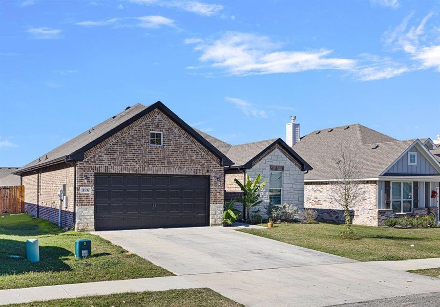 View of front facade with a front yard and a garage