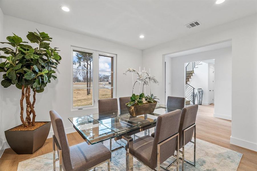 Dining area with a wealth of natural light and light hardwood / wood-style flooring