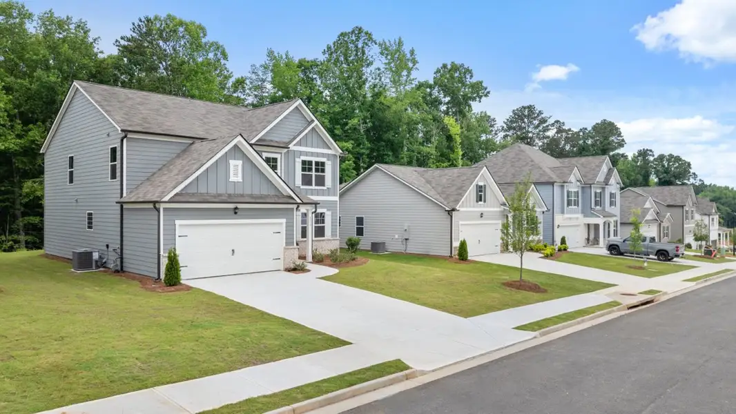 Front exterior of a new home in South Wind, Union City, GA, highlighting curb appeal (Image 2). Front exterior of a new home in South Wind, Union City, GA, highlighting curb appeal (Image 2).