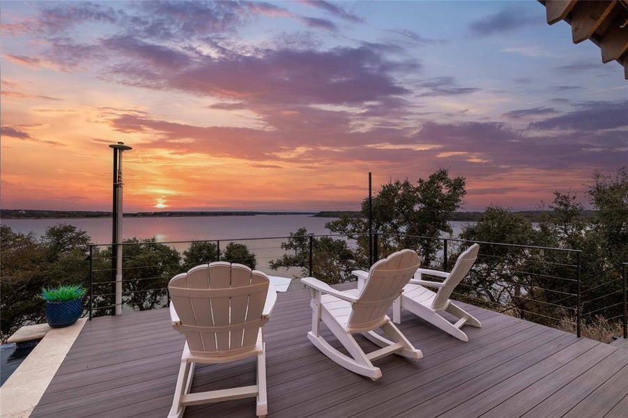 Deck at dusk featuring a water view