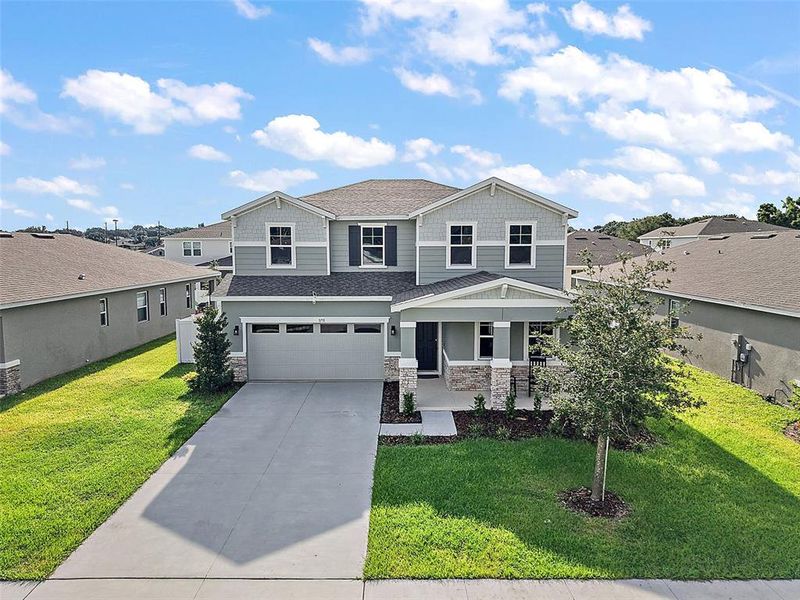 Front exterior of a new home in Seasons at Lakeside Forest, Tavares, FL, highlighting curb appeal (Image 27).