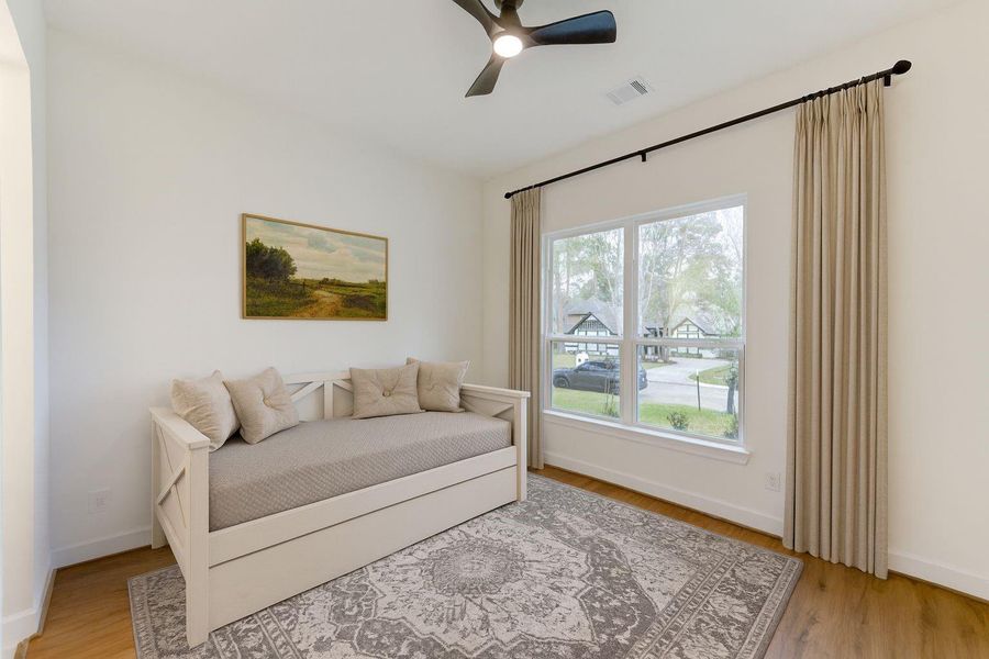 Beautifully staged fourth bedroom, complete with elegant drapes, a day bed offering a cozy and inviting space for relaxation or guests. Beautifully staged fourth bedroom, complete with elegant drapes, a day bed offering a cozy and inviting space for relaxation or guests.