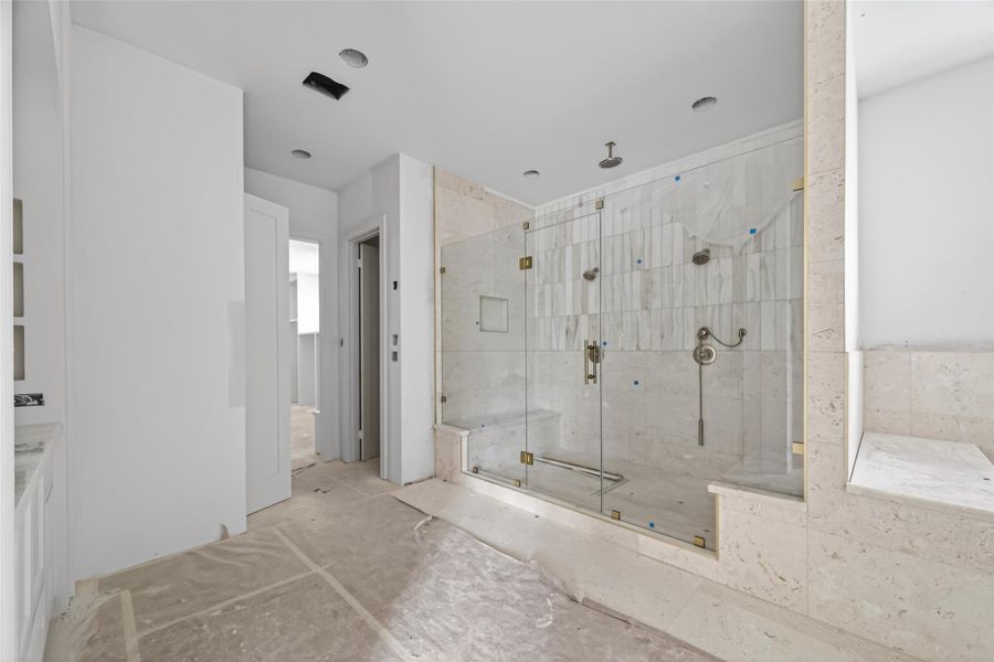 Primary boutique hotel expansive style bathroom with large double luxury vanities and massive walk in shower with tub