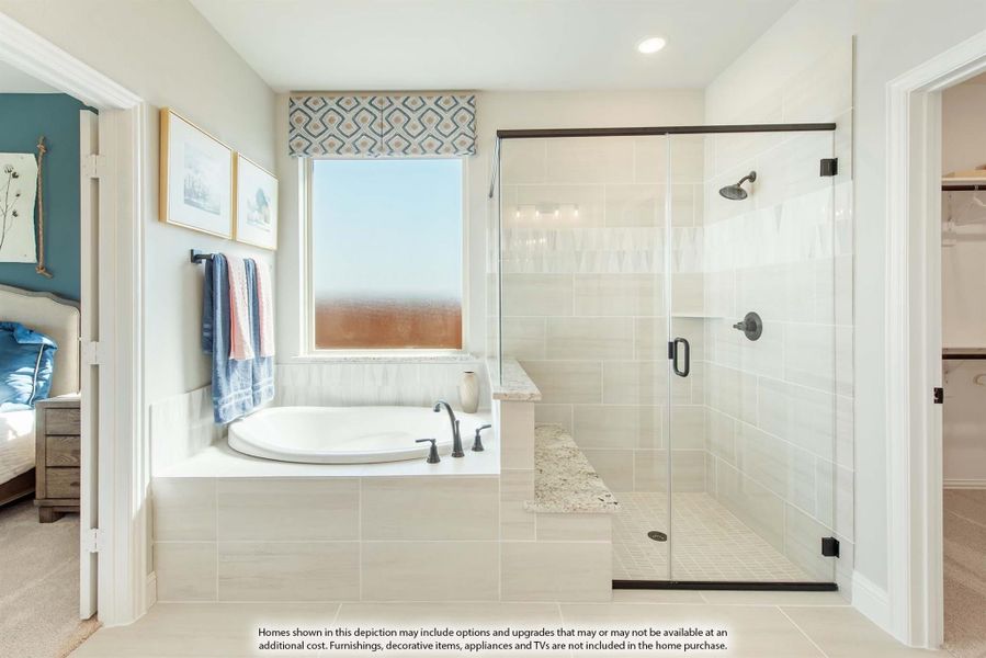 Master bathroom with soaking tub, glass-enclosed walk-in shower, and tile surround next to bedroom entrance Master bathroom with soaking tub, glass-enclosed walk-in shower, and tile surround next to bedroom entrance