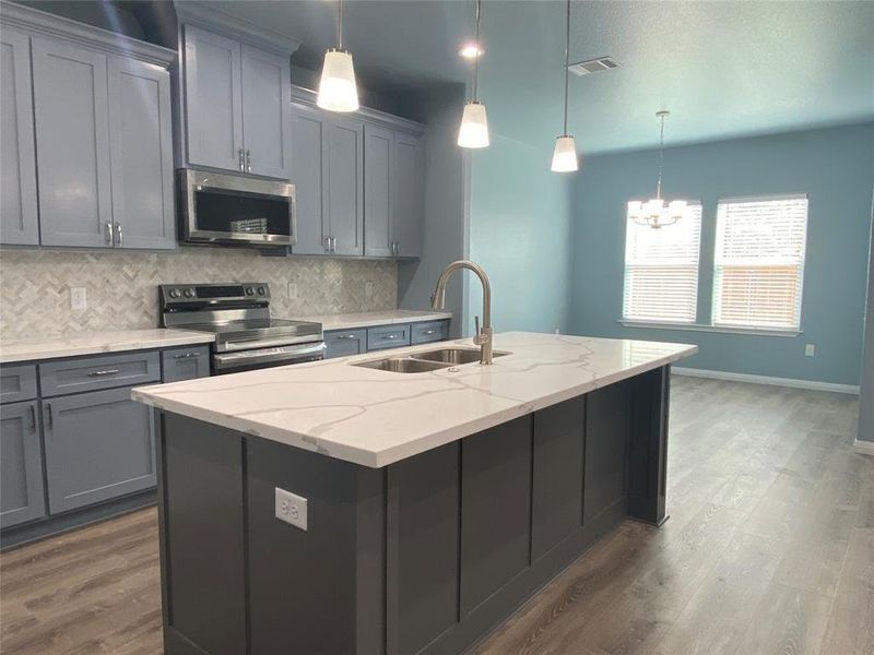 A well-appointed kitchen features a large island and ample cabinet space, flowing into an inviting dining area. A well-appointed kitchen features a large island and ample cabinet space, flowing into an inviting dining area.