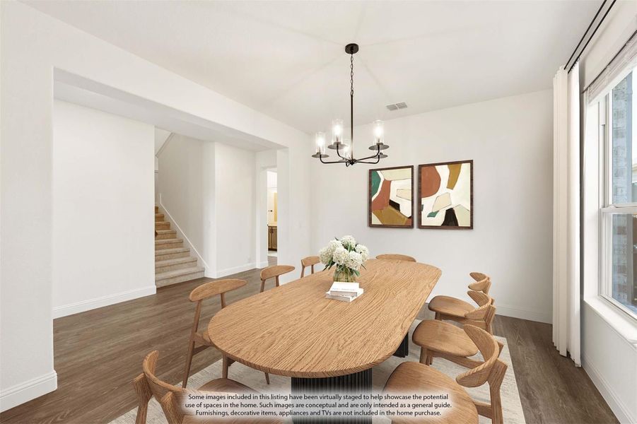 Dining room with oval wood table, eight chairs, chandelier, and hardwood floors near staircase