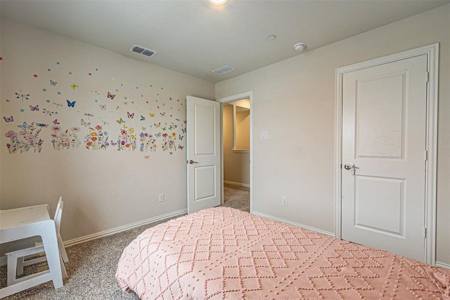 3rd bedroom with visible vents, baseboards, and carpet floors