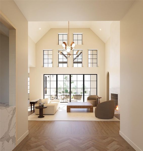 Soaring two-story vaulted ceilings and expansive black-framed windows flood the living space with natural light, seamlessly connecting indoors to the outdoor retreat. Anchored by a custom fireplace and designer lighting, this open-concept family room embodies Elevare’s signature blend of scale, warmth, and refined design.