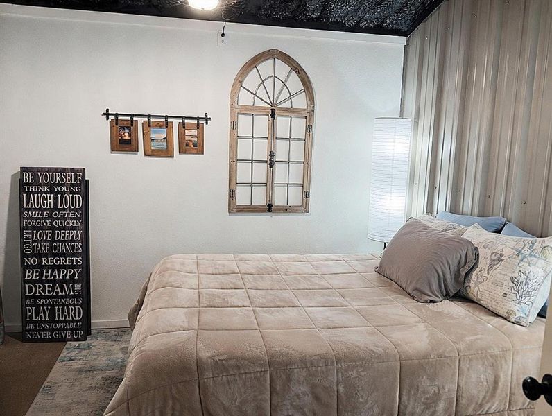 Bedroom with accent metal wall